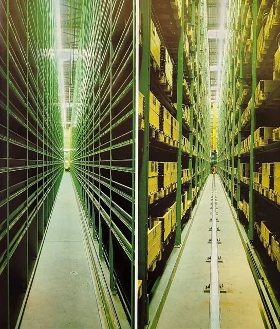 High steel pallet racks storing boxes inside a warehouse.