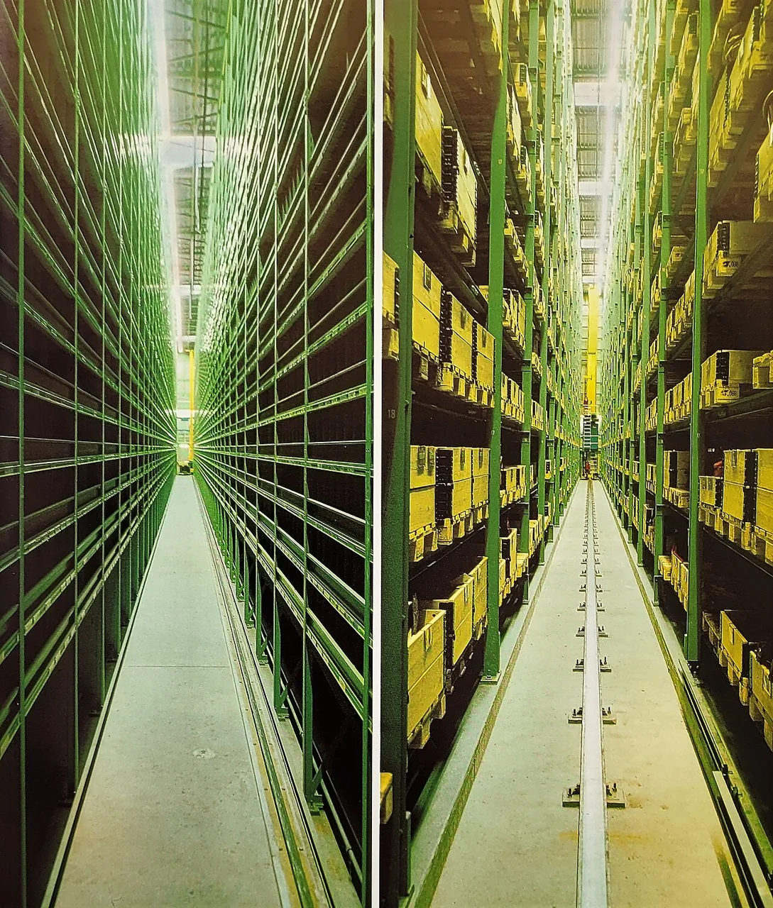 High steel pallet racks storing boxes inside a warehouse.