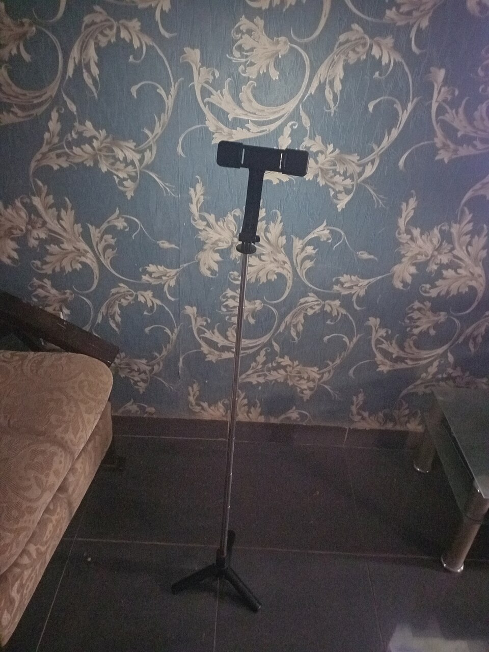 A small tripod and phone holder used for recording mobile content.