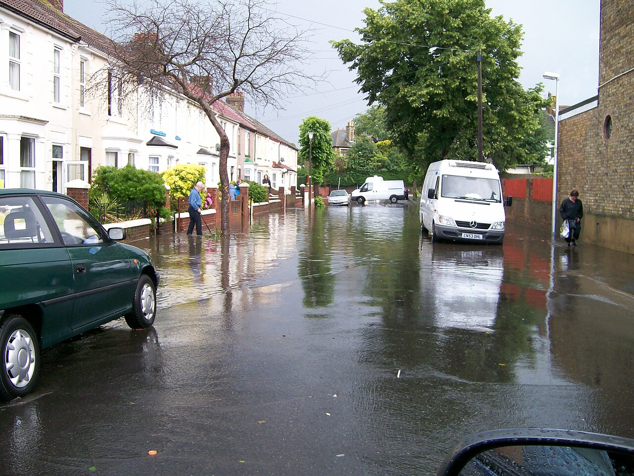 A van travelling through a flooded residential street in Gillingham, Kent.