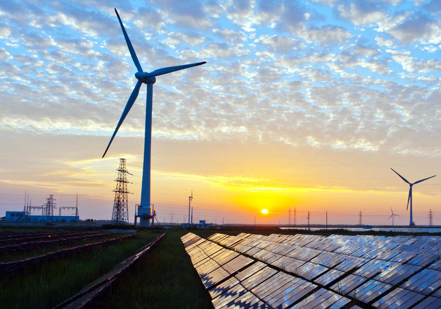 Solar panels, wind turbines and electricity pylons.